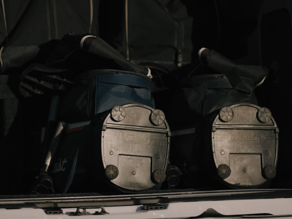 Golf bags stored in the back of Golf Cruiser vehicle